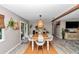 Bright dining room featuring wood table, designer lighting, and access to a cozy outdoor space at 2105 Ne 50Th Pl, Ocala, FL 34479