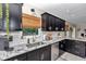 Updated kitchen with granite counters, stainless appliances, dark cabinets, and a garden view at 2105 Ne 50Th Pl, Ocala, FL 34479
