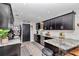 Well-lit kitchen boasts dark cabinetry, granite countertops, stainless steel appliances, and sleek backsplash at 2105 Ne 50Th Pl, Ocala, FL 34479
