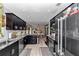 Modern kitchen featuring black cabinets, stainless steel appliances, and light wood-look flooring at 2105 Ne 50Th Pl, Ocala, FL 34479