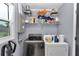 Efficient laundry room with modern washer, dryer, and shelving for ample storage at 2105 Ne 50Th Pl, Ocala, FL 34479