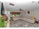 Bright living room featuring a large sectional sofa, stylish decor, and a cozy atmosphere at 2105 Ne 50Th Pl, Ocala, FL 34479
