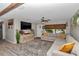 Comfortable living room with a large sectional sofa, decorative rug, and a view of the front yard at 2105 Ne 50Th Pl, Ocala, FL 34479
