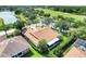 A sunny aerial view showcases the roof, landscaping, screened-in porch, and proximity to a golf course at 217 Lake Cassidy Dr, Kissimmee, FL 34759