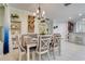 Dining room features a stylish chandelier, wine rack, and ample natural light at 217 Lake Cassidy Dr, Kissimmee, FL 34759