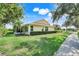 Beautiful one story home with lush landscaping, manicured lawn, and a screened in porch on a sunny day at 217 Lake Cassidy Dr, Kissimmee, FL 34759