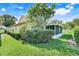 A one story home with lush landscaping, including a screened in porch surrounded by manicured hedges at 217 Lake Cassidy Dr, Kissimmee, FL 34759