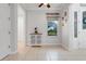 Bright foyer with decorative cabinet and window offering natural light and views at 217 Lake Cassidy Dr, Kissimmee, FL 34759
