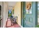 Inviting screened porch with seating and a decorative wreath on the front door at 217 Lake Cassidy Dr, Kissimmee, FL 34759