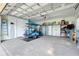 Spacious garage with an electric golf cart, storage solutions, and brick flooring at 217 Lake Cassidy Dr, Kissimmee, FL 34759