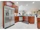 Bright kitchen boasts stainless steel appliances, granite countertops, and tile flooring at 217 Lake Cassidy Dr, Kissimmee, FL 34759