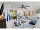 Open-concept living room with a ceiling fan, neutral decor, and sliding glass doors to the patio at 217 Lake Cassidy Dr, Kissimmee, FL 34759