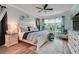 Serene main bedroom boasts a ceiling fan, plush rug, and a sunlit window at 217 Lake Cassidy Dr, Kissimmee, FL 34759