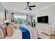 Bright and airy main bedroom featuring a ceiling fan, large window, and modern dresser at 217 Lake Cassidy Dr, Kissimmee, FL 34759