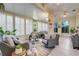 Spacious sunroom offers multiple seating areas, natural light, and a relaxing atmosphere at 217 Lake Cassidy Dr, Kissimmee, FL 34759