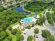Stunning aerial view of community pool, lake, and amenities in a desirable neighborhood, perfect for relaxation and recreation at 2308 Bur Oak Ct, Oviedo, FL 32766