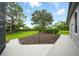 The backyard features a manicured lawn, mature trees, and lovely landscaping at 2308 Bur Oak Ct, Oviedo, FL 32766