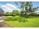 A vibrant green lawn is enhanced by mature trees and privacy hedges at 2308 Bur Oak Ct, Oviedo, FL 32766