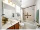 Clean bathroom featuring a shower-tub combo with decorative tile accents, a single sink vanity, and a large mirror at 2308 Bur Oak Ct, Oviedo, FL 32766