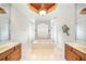 Bathroom featuring dual sinks, a centered tub, decorative ceiling, and a lobster wall decor at 2308 Bur Oak Ct, Oviedo, FL 32766