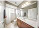Bathroom featuring a large mirror and a shower with white tile at 2308 Bur Oak Ct, Oviedo, FL 32766