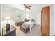 Cozy bedroom with a single bed, complemented by a decorative trunk, side table, and ample natural light from the window at 2308 Bur Oak Ct, Oviedo, FL 32766
