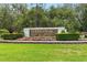 Welcome to Live Oak Reserve, featuring a beautiful stone entrance amidst lush landscaping at 2308 Bur Oak Ct, Oviedo, FL 32766