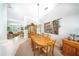 Cozy dining area with chandelier, wooden table, and a decorative tapestry at 2308 Bur Oak Ct, Oviedo, FL 32766