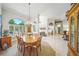 Airy dining area featuring a chandelier and lots of natural light from large arched windows at 2308 Bur Oak Ct, Oviedo, FL 32766