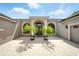 Close up view of a one story home with an arched entry and paver driveway at 2308 Bur Oak Ct, Oviedo, FL 32766