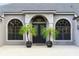 Close up view of a one story home with an arched entry and paver driveway at 2308 Bur Oak Ct, Oviedo, FL 32766
