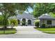 View of a one story home with a well maintained paver driveway and landscaping at 2308 Bur Oak Ct, Oviedo, FL 32766