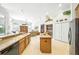 Bright, open kitchen featuring a central island and views into the living area at 2308 Bur Oak Ct, Oviedo, FL 32766