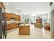 Open kitchen with wood cabinets, central island and views of living area at 2308 Bur Oak Ct, Oviedo, FL 32766