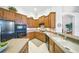 Well-equipped kitchen with wooden cabinets, stainless steel appliances, and a functional layout for efficient cooking at 2308 Bur Oak Ct, Oviedo, FL 32766