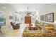 Spacious living room with tile flooring, a ceiling fan, and a comfortable seating arrangement, great for relaxing and socializing at 2308 Bur Oak Ct, Oviedo, FL 32766