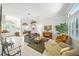 Bright living room with neutral tiling, comfortable seating, a decorative piano, and stylish decor at 2308 Bur Oak Ct, Oviedo, FL 32766