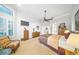 Well-lit main bedroom with a ceiling fan, television, and classic wooden furniture at 2308 Bur Oak Ct, Oviedo, FL 32766