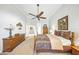 Bright main bedroom featuring a ceiling fan, traditional furniture, and ample lighting at 2308 Bur Oak Ct, Oviedo, FL 32766