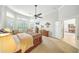 Bright main bedroom featuring a ceiling fan, traditional furniture, and a sun-filled seating area at 2308 Bur Oak Ct, Oviedo, FL 32766