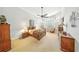 Comfortable main bedroom with ceiling fan, neutral decor, and several windows at 2308 Bur Oak Ct, Oviedo, FL 32766