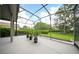 The screened lanai provides an excellent view to enjoy the manicured yard at 2308 Bur Oak Ct, Oviedo, FL 32766