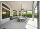 A screened lanai offers ceiling fans and ample seating to enjoy the outdoors at 2308 Bur Oak Ct, Oviedo, FL 32766