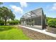 Tranquil outdoor space featuring a screened lanai surrounded by verdant landscaping at 2308 Bur Oak Ct, Oviedo, FL 32766