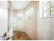 Bright shower area with tiled walls, a built in bench, and a window at 2308 Bur Oak Ct, Oviedo, FL 32766