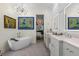 Elegant bathroom with a soaking tub, double vanity, and stylish decor at 2456 Northumbria Dr, Sanford, FL 32771