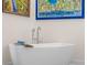 Modern bathroom featuring a freestanding tub with chrome fixtures and art on the walls at 2456 Northumbria Dr, Sanford, FL 32771