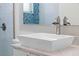Bathroom featuring blue mosaic tile, walk-in shower, floating vanity and chrome fixtures at 2456 Northumbria Dr, Sanford, FL 32771