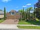 Beautiful two-story home featuring a stone facade, manicured lawn and a two car garage at 2456 Northumbria Dr, Sanford, FL 32771