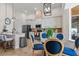 Open kitchen featuring a glass-top dining table, stainless steel appliances, and white cabinetry at 2456 Northumbria Dr, Sanford, FL 32771